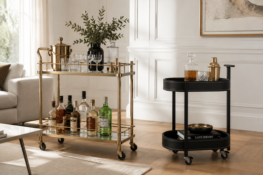 Drinks trolley vs bar cart — gold rectangular bar cart with bottles and glassware beside a compact black round drinks trolley in an elegant Australian living room