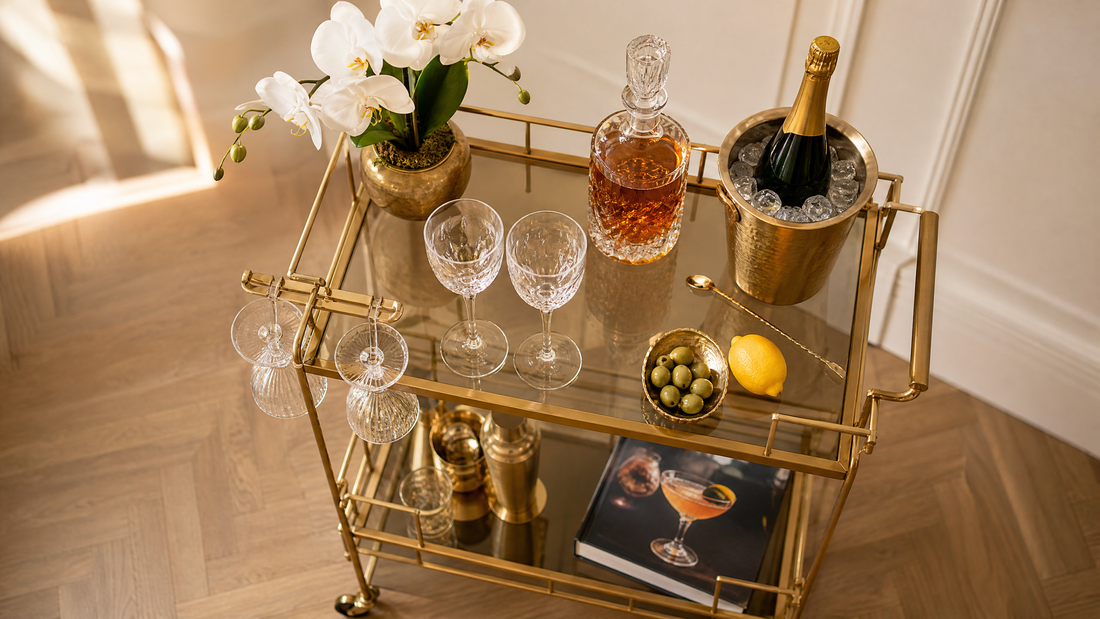 What to put on a bar cart — beautifully styled gold bar cart with spirits, crystal glassware, cocktail tools, flowers and decanter