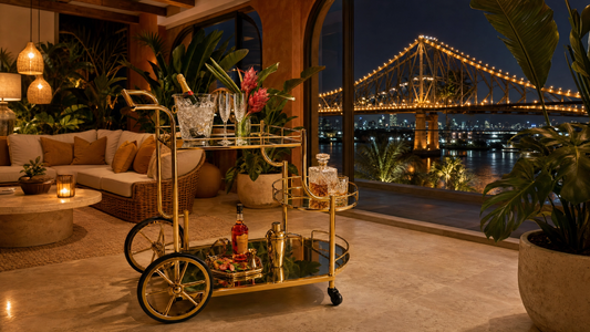 Drinks trolley Brisbane — gold bar cart in a tropical luxury home with Story Bridge lit up over the Brisbane River at night
