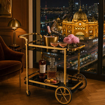 Le Versailles gold drinks trolley in luxury Melbourne apartment overlooking CBD skyline and Eureka Tower at night