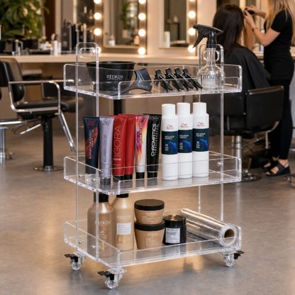 Crystal Clear Acrylic Rolling Salon Cart in hair salon — clear acrylic hairdressing trolley with ergonomic push handles