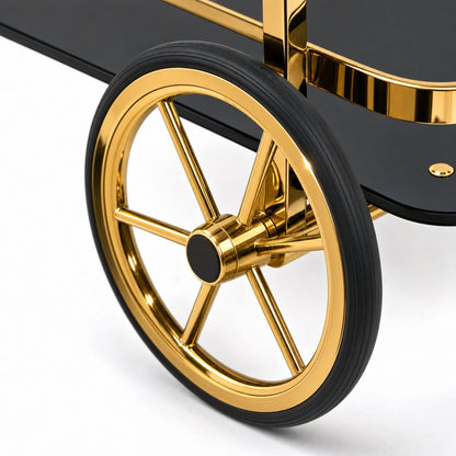 Close-up of Le Versailles gold bar cart decorative rubber spoke wheels and front swivel casters