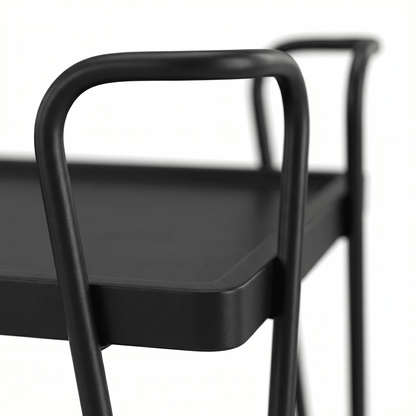 Close-up of The Ascot Vale Two-Tier Retro Serving Cart’s black frame and brown shelves styled with glassware in a contemporary setting
