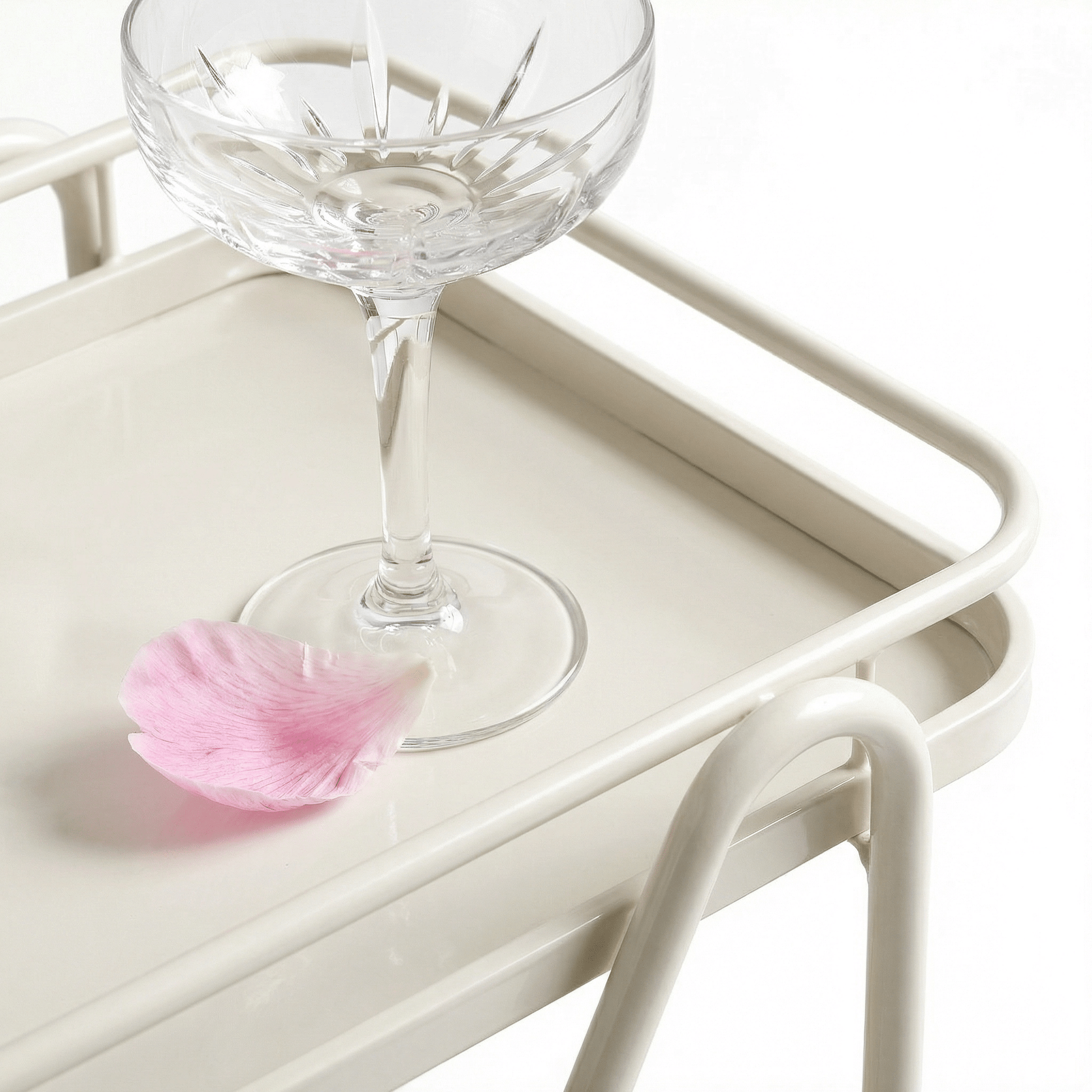 Close-up of the Brighton Two-Tier Metal Service Cart in black, styled with glassware and coastal deco accents by Royal Bar Carts.