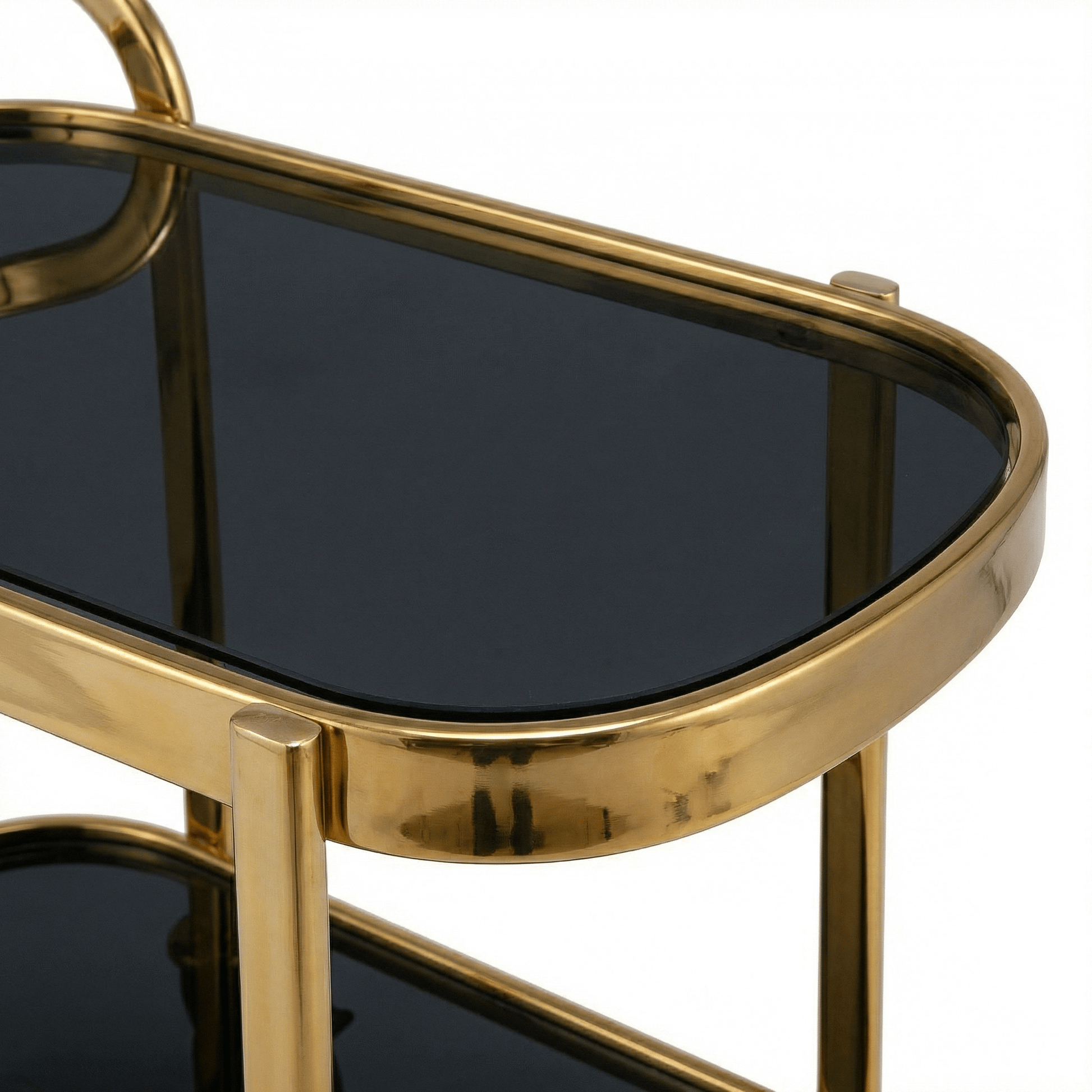 Close-up of The Collins Two-Tier Beverage Cart’s gold frame and glass shelves styled with cocktail glasses and barware in a cosy lounge.