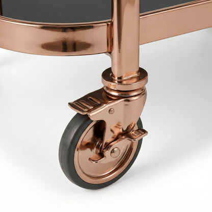 Close-up of the Collins Two-Tier Beverage Cart’s gold frame and glass shelves styled with elegant barware and deco accents.