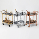 The Collins Two-Tier Beverage Cart by Royal Bar Carts in gold, Silver and Rose featuring glass shelves and Gatsby deco style Bar Cart