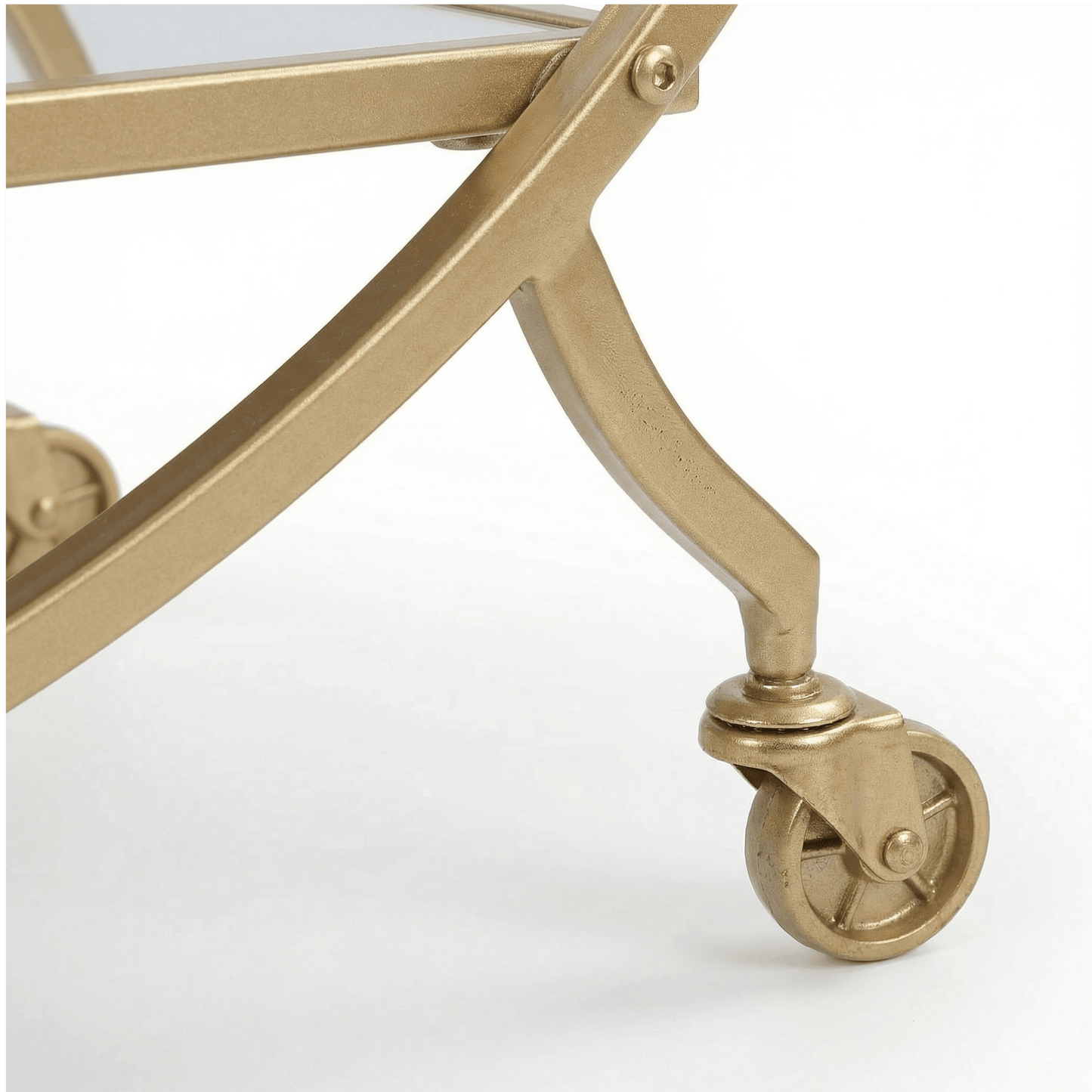Close-up of The Orion Gold Circle Bar Cart’s glass shelves and gold frame, styled with elegant glassware by Royal Bar Carts.