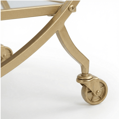 Close-up of The Orion Gold Circle Bar Cart’s glass shelves and gold frame, styled with elegant glassware by Royal Bar Carts.