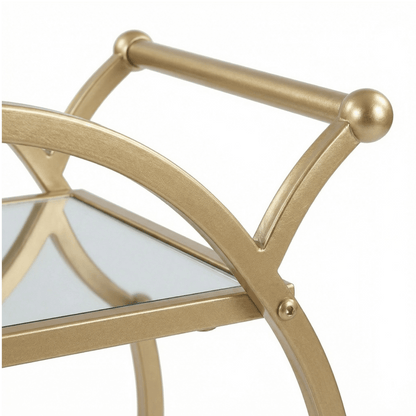 Close-up of the Orion Gold Circle Bar Cart’s sleek glass shelves and gold frame, styled with elegant glassware and cocktails