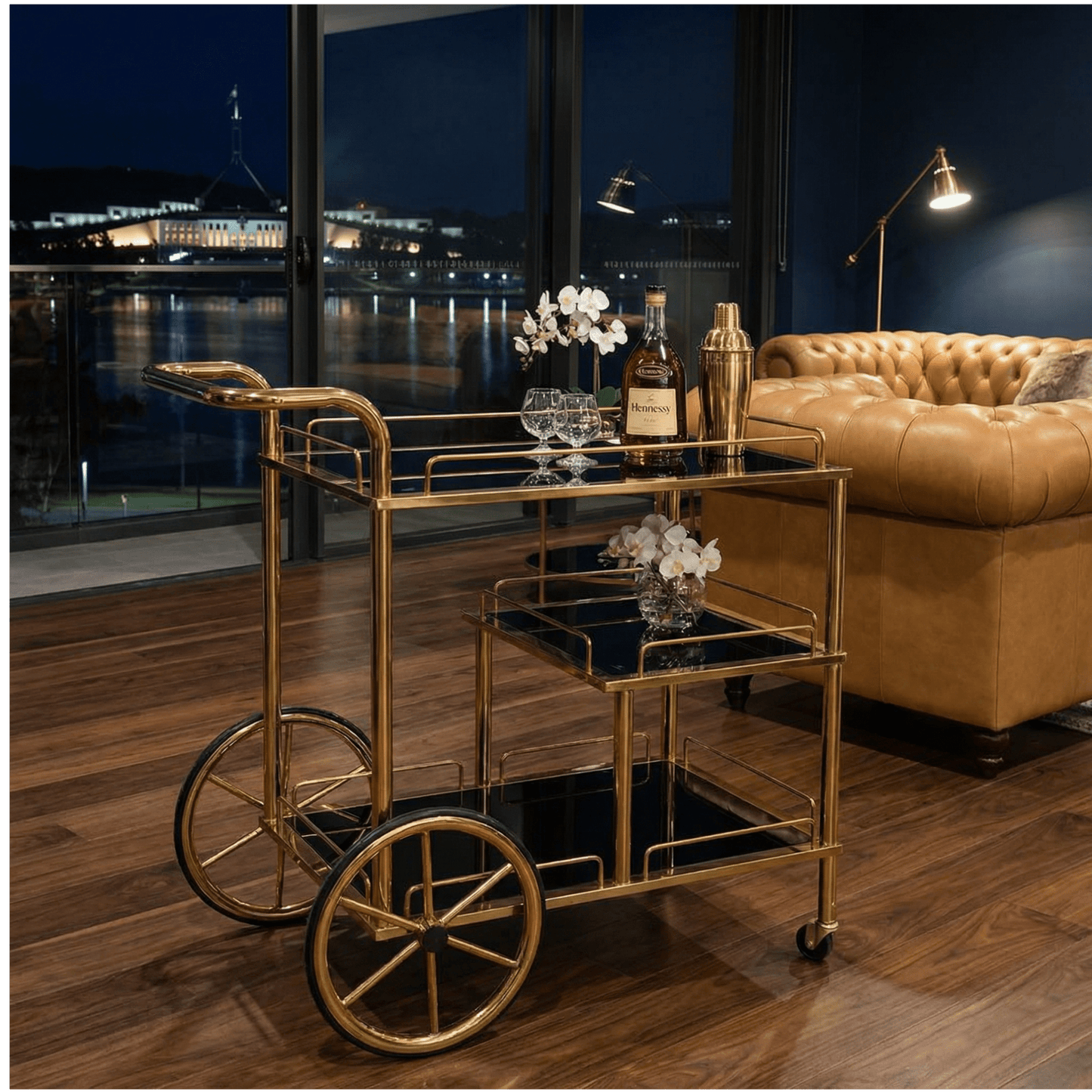 Close-up of Sovereign Bar Cart’s sleek black frame and glass shelves styled with contemporary deco accessories.