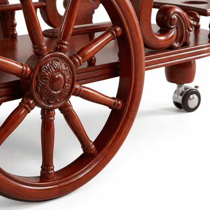 Close-up of The Tasman Ornate Wood Bar Trolley’s intricate wood detailing and brass accents in a stylish home setting