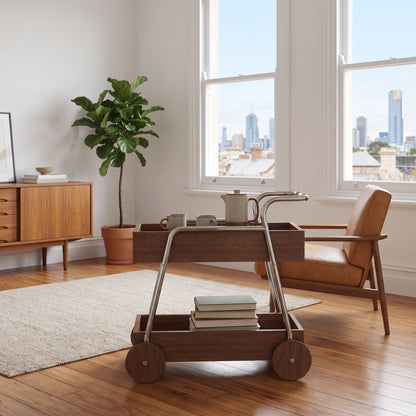 The Carlton Mid-Century Solid Wood Drinks Trolley in walnut in a Carlton terrace-house living room, the Melbourne skyline through the sash windows