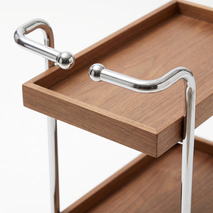 Close view of The Carlton's two ball-ended chrome-look handle arms above the walnut upper tray, with the open gap between them