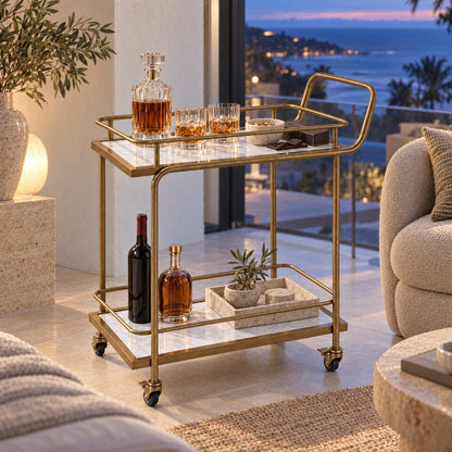 The Subiaco Nordic Service Trolley in Aged Brass with white marble-look shelves in a Noosa master suite at dusk, the coastline through the window